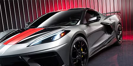 Hero shot of a gray coupe with a red hood wrap.
