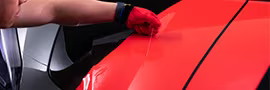 Detail shot of the wrap installer applying film with 3M™ Knifeless Tape.